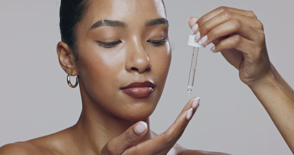 Close-up of woman applying AHA Peeling Concentrate – The North DNA clean skincare, reduces dark spots, brightens skin and promotes an even radiant tone